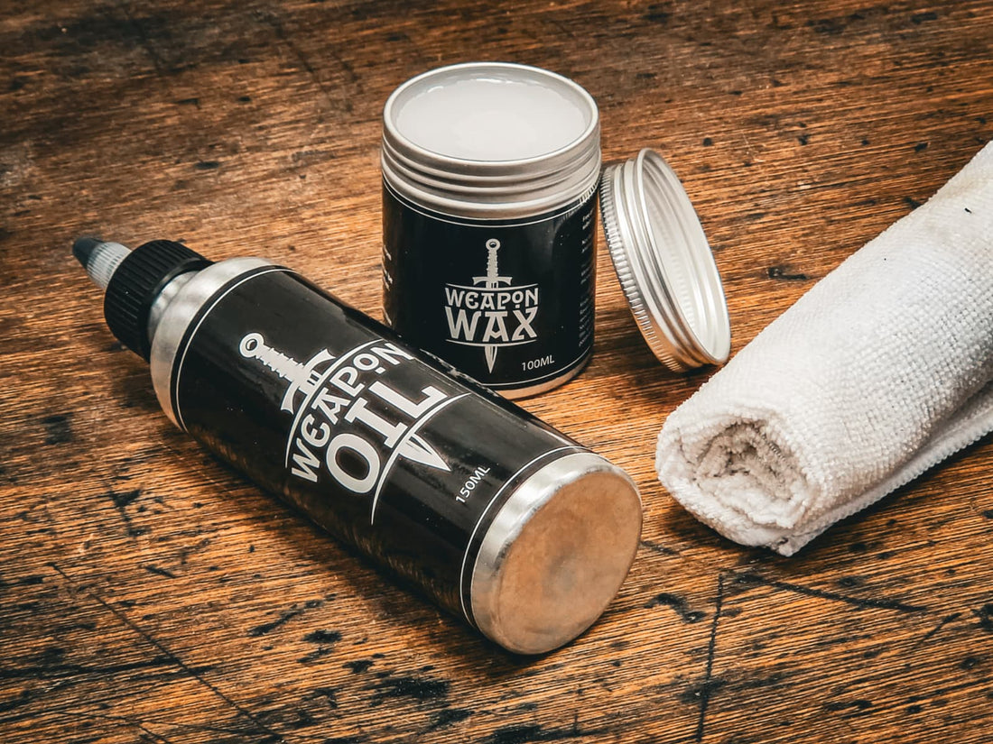 Raven Forge Weapon Oil, Weapon Wax and a cloth on a workbench