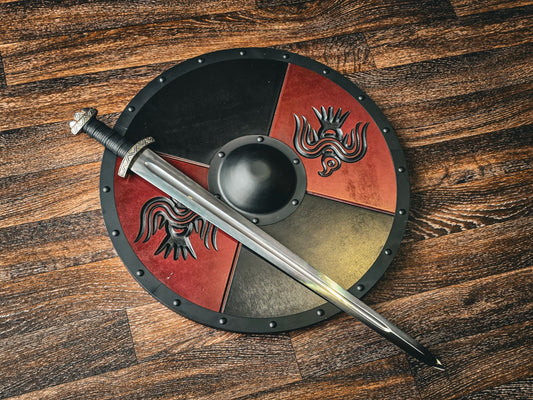 Viking round shield with a sword laid across it