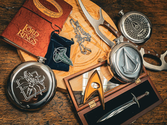 Officially licensed collectibles including hip flasks, jewellery and a letter opener