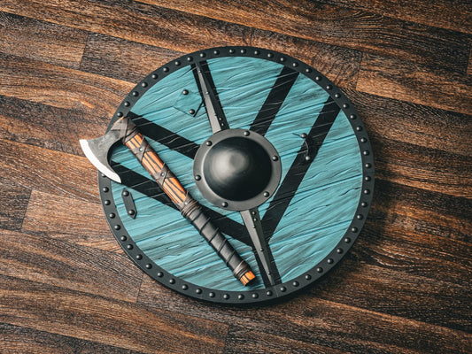 Teal Viking round shield with a hand axe laid across it